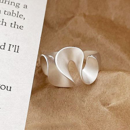 A sterling silver ring from the set featuring a unique wavy design.