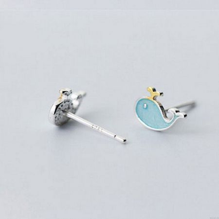 Detailed view of the sterling silver whale stud earrings showcasing the blue enamel and gold accent details.