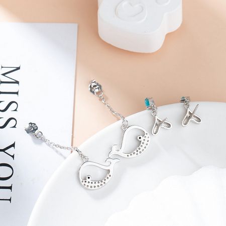 Complete ocean-themed jewelry set with whale earrings and a matching necklace.