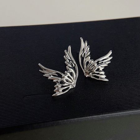 A pair of silver-plated butterfly stud earrings shown from a slightly different angle.