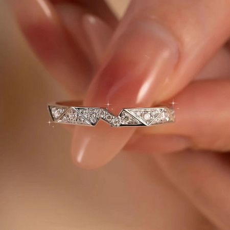 Detailed view of the woman's origami ring with a zigzag pattern and pavé cubic zirconia.
