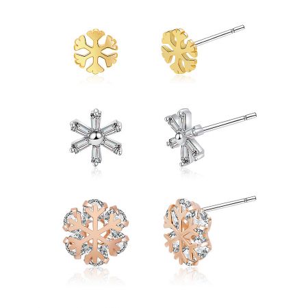 A close-up view highlighting the brilliant cubic zirconia stones on the snowflake earrings in gold, silver, and rose gold.