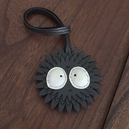 Detailed view of the Soot Sprite leather charm, emphasizing its quality craftsmanship and cute design.