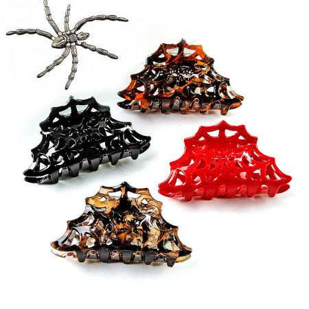 Four spider web hair clips in different colors with a decorative spider.