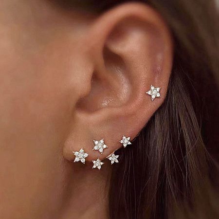Model wearing the sparkling mini star zircon stud earring to show scale and style.