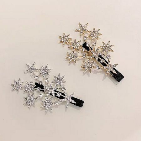 Wholesale Sparkly Crystal Star Hair Clips (5 pcs) - A pair of sparkly crystal star hair clips, one in a polished gold finish and the other in a brilliant silver finish, displayed side-by-side.