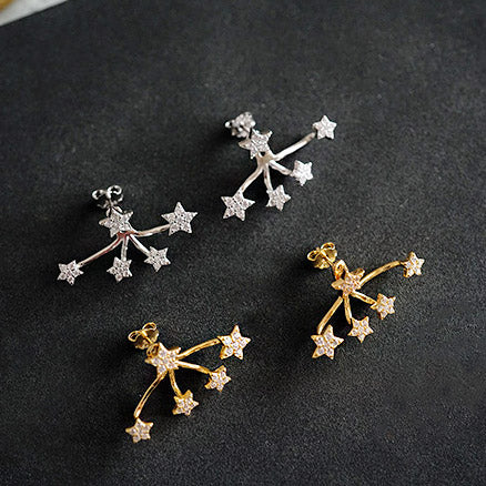 An assortment of the 925 sterling silver mini star earrings in both silver and gold finishes.