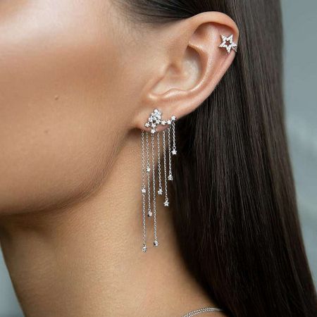 Side view of the star-themed dangling earring, highlighting the long chain and cubic zirconia details.