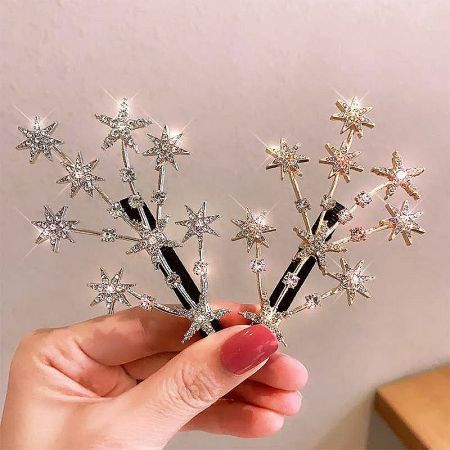 Detailed view of the gold and silver star-studded hair clips, showing the intricate crystal details.