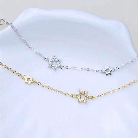 Matching star-themed necklaces available in both silver and gold, perfect for creating a complete jewelry set.