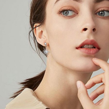 A model showcasing the Latelita Rhodium Star Bridal Earrings, highlighting how they complement facial features.