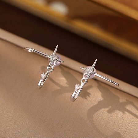 A pair of sterling silver starfish stud earrings with sparkling gemstone accents.