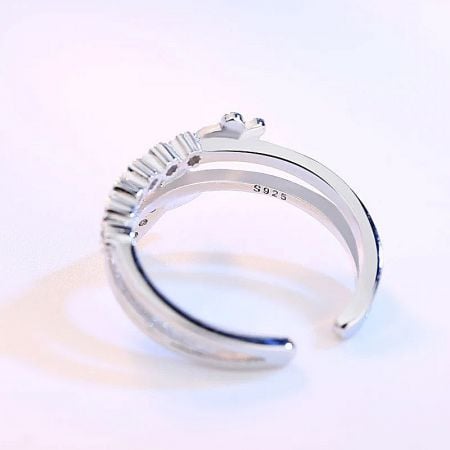 Close-up of a sterling silver ring with a row of baguette-cut zircon stones.