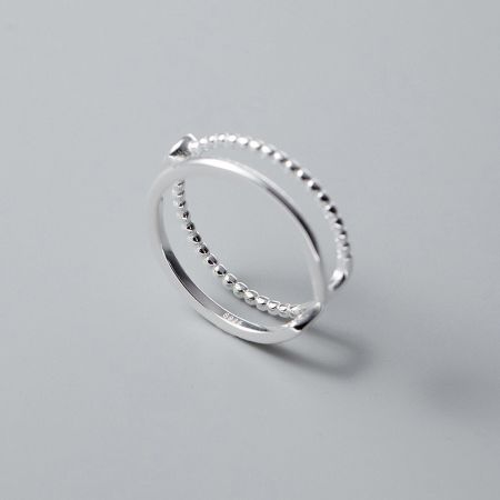 A sterling silver ring from the set featuring a unique beaded texture and double-layer design.