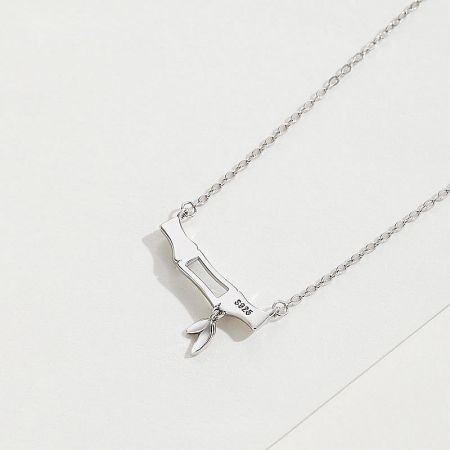 Sterling silver necklace showcasing a modern rectangular pendant with a central cutout and S925 stamp.