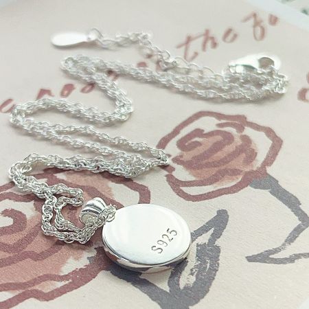 Detailed view of the S925 sterling silver stamp on the necklace pendant, ensuring authenticity.