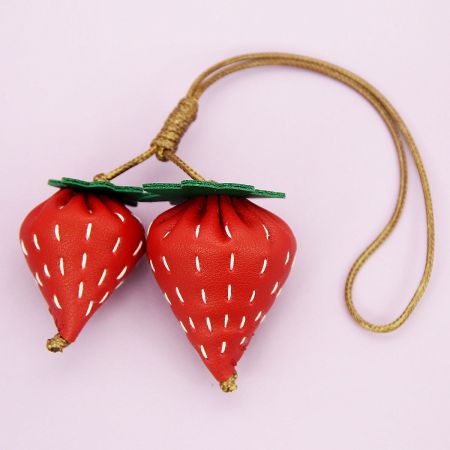 A set of strawberry-shaped PU leather charms, perfect for use as bag accessories or keychains.