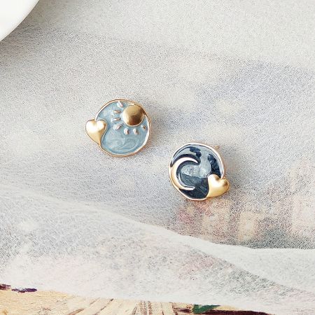 14k Gold Plated Blue Enamel Asymmetrical Sun Moon Heart Stud Earrings (5 Pairs) - A pair of 14k gold-plated stud earrings with blue enamel, featuring an asymmetrical design of a sun and a wave, each with a small heart accent.