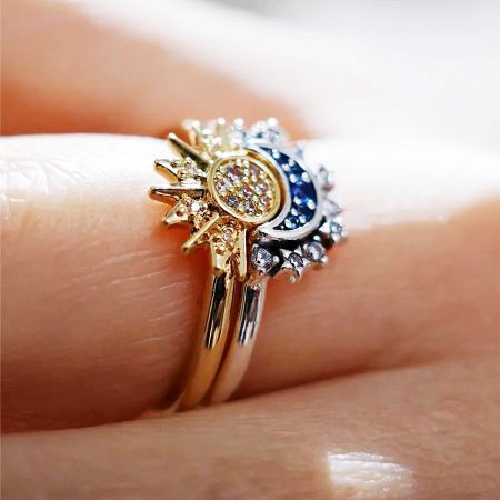 Detailed view of the sunburst ring from the Solar System set, featuring intricate gold detailing with white diamonds and blue gemstones.