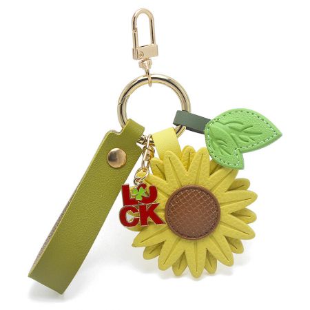 Close-up of the lucky sunflower keychain with a PU leather strap and a four-leaf clover charm for exam success.