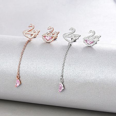 A collection of four swan-shaped earrings in both rose gold and silver, highlighting the pink gemstone accents.