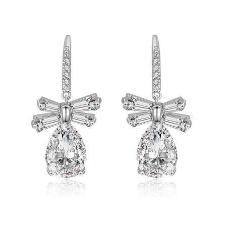 White CZ Oval Drop Bow Earrings - Front view of the White CZ Oval Drop Bow Earrings, featuring a large teardrop-shaped cubic zirconia stone set in rhodium-plated brass with a delicate bow detail.