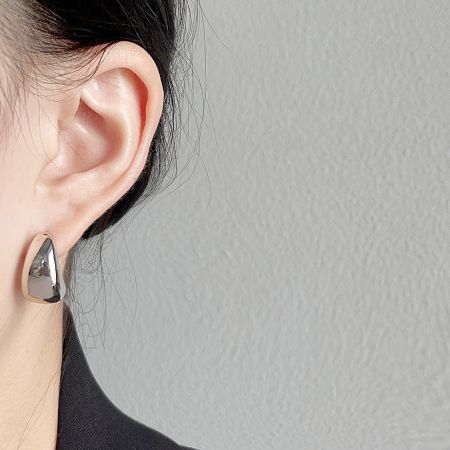 Side profile of a model showcasing the elegant teardrop shape of the earring.
