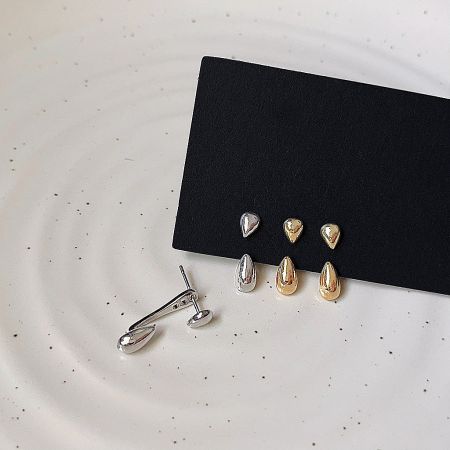 A collection of the drop shape ear studs in both polished gold and silver finishes.