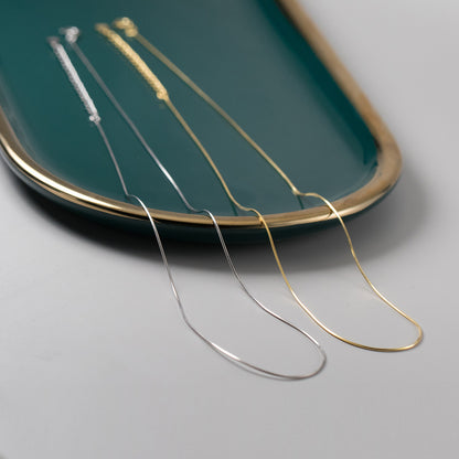 The set of five sterling silver snake chain necklaces displayed on a tray.