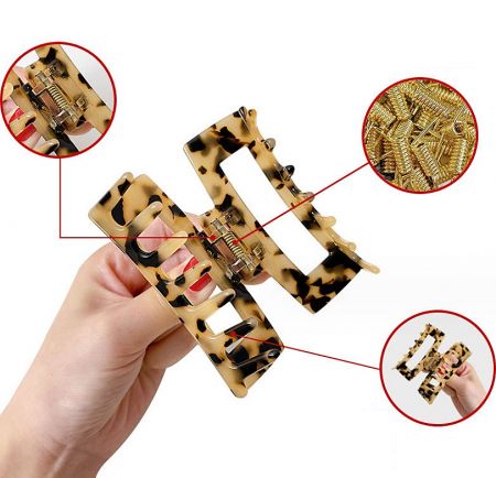 Close-up of a classic tortoiseshell acetate hair clip with a durable gold metal clasp.