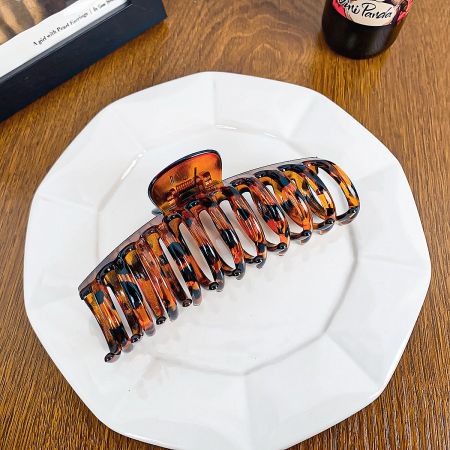 Close-up of a classic tortoiseshell pattern hair claw clip.