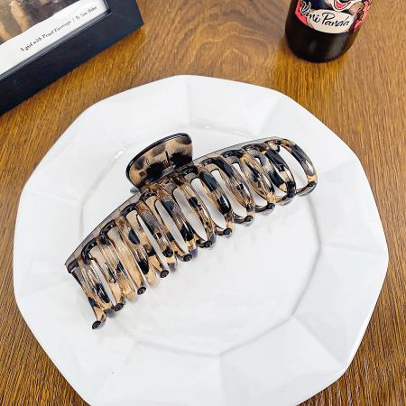 The trendy leopard print hair claw clip, perfect for a bold look.