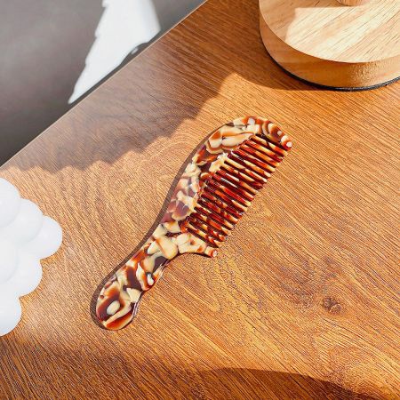 Close-up of a classic tortoiseshell patterned acetate hair comb.