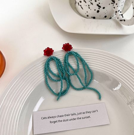 Beaded-Flower Drop Earrings - A pair of Beaded-Flower Drop Earrings (JRE-179) with vibrant turquoise beads and red flower tops, elegantly displayed on a white surface.