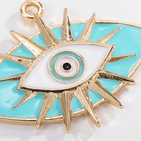 Detailed view of a single sunburst-style evil eye pendant with turquoise, white, and gold accents.