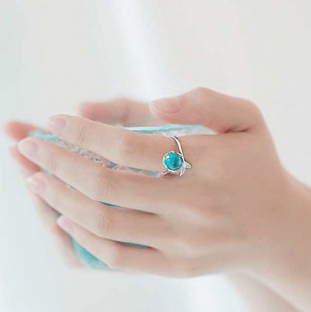 Detailed view of an ocean-themed turtle ring with a turquoise stone, part of the silver ring set.