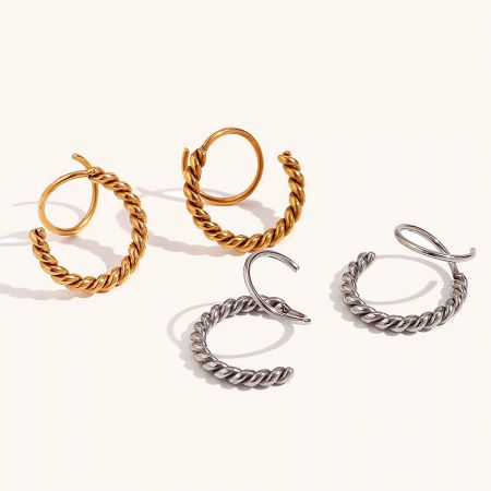 A collection of four pairs of illusion spiral twist earrings in both gold and silver finishes.