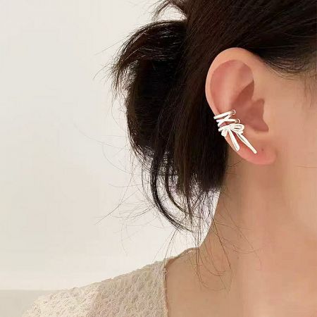 Another angle of the stylish silver bow ear cuff being worn.