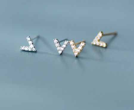 Close-up view of the 925 Sterling Silver V Letter Earrings in silver and gold finishes, highlighting the cubic zirconia stones.