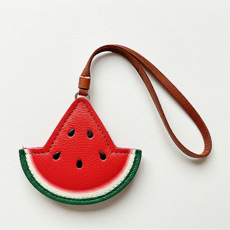A stylish watermelon slice-shaped leather pouch with a convenient wrist strap.
