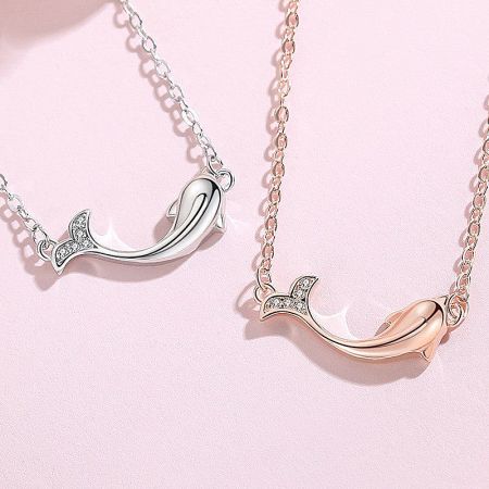 Alternative ocean-themed whale tail necklaces available in silver and rose gold.