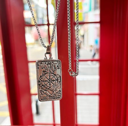 Full view of the Wheel of Fortune tarot necklace on a chain, displaying the complete piece.