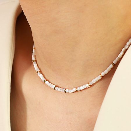 Waterproof Stainless Steel White Shell Beads Chain Choker Necklace (Set of 5) - A model showcasing the elegant waterproof stainless steel necklace with white shell beads and a gold-tone finish.