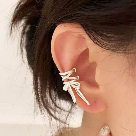 Model wearing the sterling silver matte bowknot ear cuff to showcase its fit and style.