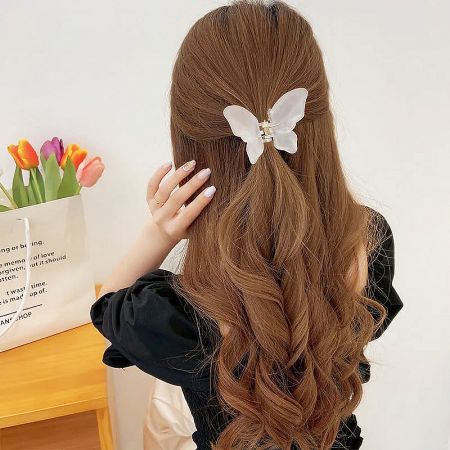 A model showcasing a white butterfly hair clip in her styled hair.