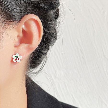 Model wearing the cute flower and cherry enamel stud earring.