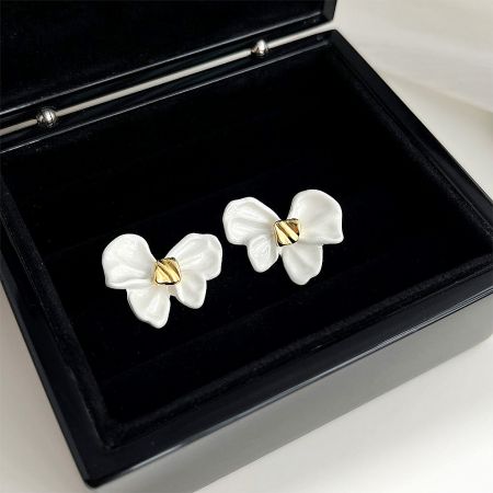 The gold-plated knot bow earrings presented in a professional black jewelry box, ideal for retail display.
