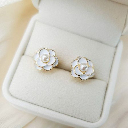 The Camellia flower stud earrings presented beautifully in a white jewelry box.