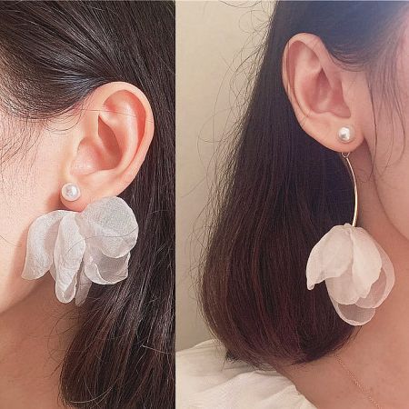 Another angle of the white flower earrings with a single pearl stud, perfect for an online store catalog.