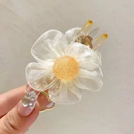 Detailed shot of the delicate beige lace flower hair clip.